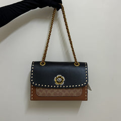 Coa.ch Parker with rivets sling