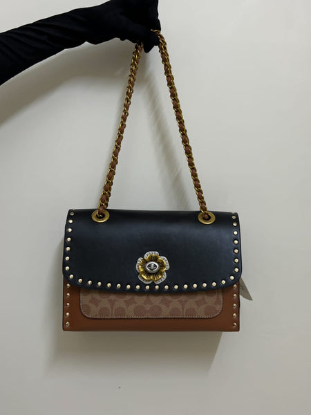 Coa.ch Parker with rivets sling