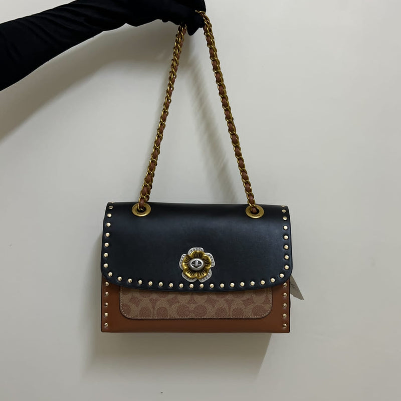 Coa.ch Parker with rivets sling